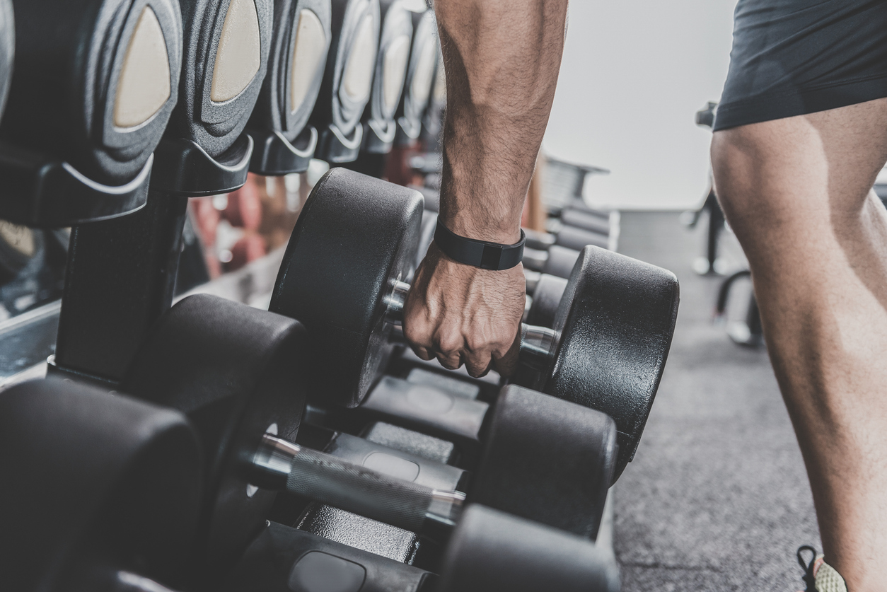 Man picking up dumbbell 