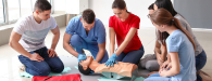 Female Lifeguard Performing CPR on Dummy.