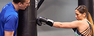 woman striking punching bag