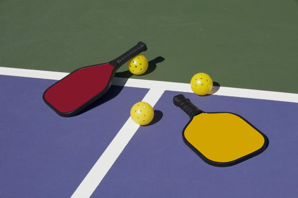 Pickleball Colorful Paddles Ball And Court Mayfair Clubs Fitness pickleball-colorful-paddles-ball-and-court-mayfair-clubs-fitness