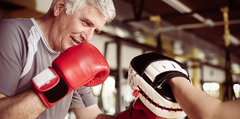 Senior man boxing