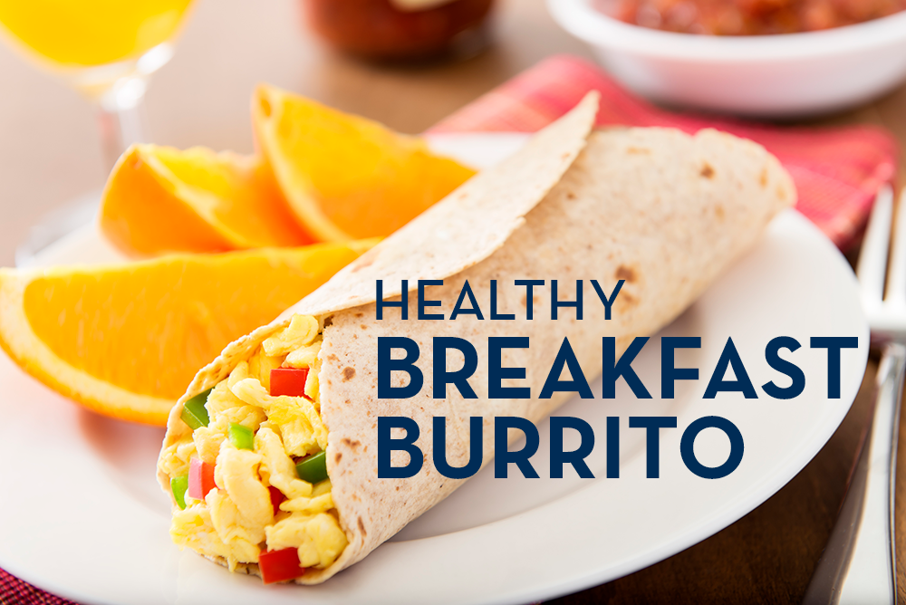 Image of a Healthy Breakfast Burrito stuffed with scrambled eggs and peppers with orange slices.