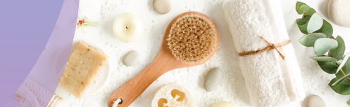 Decorative image with white background with hair brush and items used in a spa like a towel and soap.