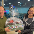 Picture of Mayfair Members who won the prize for Saint Patrick's day. They are standing in the lobby of our Mayfair Parkway Club holding up the basket with the prize.
