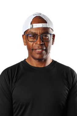 Headshot of our Group Fitness Director Al Greene in a black shirt and wearing a backwards baseball cap.