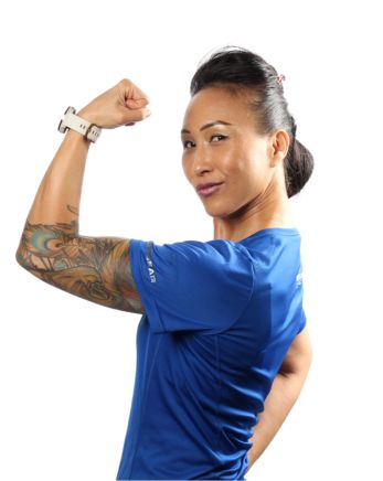 Headshot of Angel Mok, group fitness instructor and personal trainer at Mayfair Clubs. She is lifting up her arm and clinching her fist.