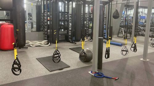 Image of boxing area, with trx equipment and suspended boxing bags in our Lakeshore fitness facility.