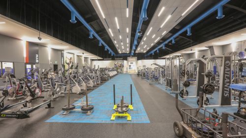 Image of the track in the fitness facility at Mayfair Lakeshore Club. the image shows weight and cardio equipment in the background left and right.