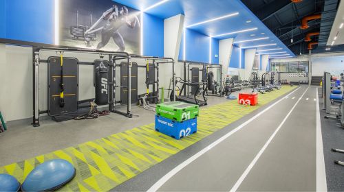 Image of the track and boxing area with suspended boxing bags and TRX equipment in the Fitness Facility at our Mayfair West location.