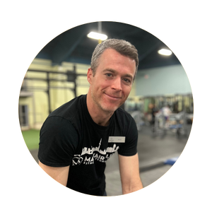 Headshot image of personal trainer Alex Swift in the gym.